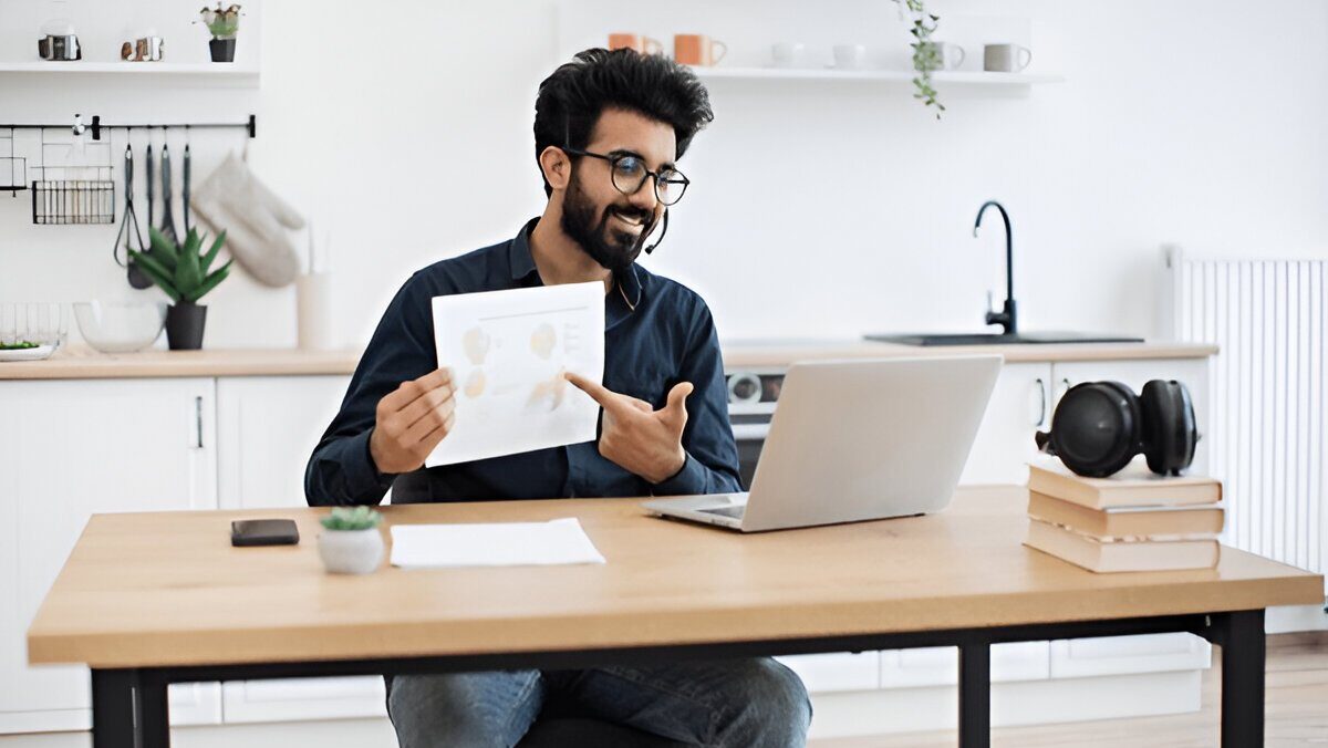 Online learner attending virtual class at home workspace with laptop
